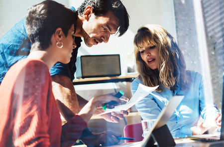 Concept of business team at working process.Young professionals work with new market project. Project managers meeting.Blurred background.Horizontal.Cropped.の写真素材