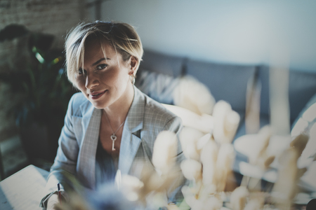 Portrait of smiling young beautiful woman at livingroom. pretty girl smile while looking at the camera. Blurred background.の写真素材