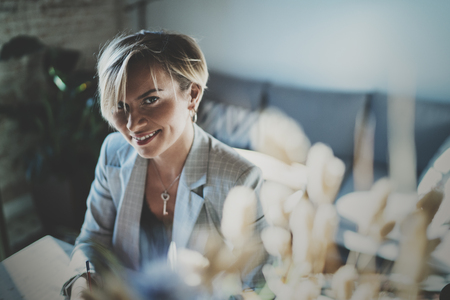 Portrait of smiling young beautiful woman at livingroom. pretty girl smile while looking at the camera. Blurred background.の写真素材
