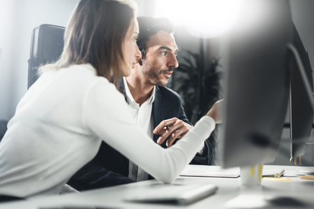 Group of two business person at working process.Young professionals work with new market project. People using computer.Blurred background.Horizontal.の写真素材