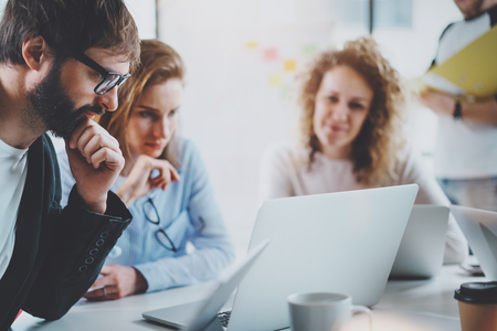 Teamwork process concept.Happy coworkers working with new startup project at sunny office.Horizontal, blurred background.の写真素材