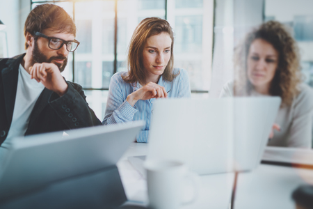Business meeting concept.Coworkers team working with mobile computer at modern office.Blurred background.Horizontal.の写真素材