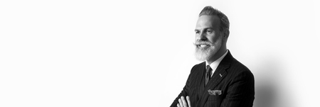 Portrait of bearded attractive gentleman wearing trendy suit over empty white background. Copy Paste text space. Wide. Black and Whiteの写真素材