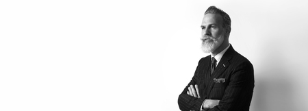 Portrait of bearded confident businessman wearing trendy suit over empty white background. Copy Paste text space. Wide. Black and Whiteの写真素材