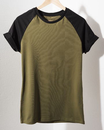 Front view of American Hipsters retro classic tshirt clothes. Blank template of vintage t-shirt hanging on a hanger on white background. Closeup.の写真素材