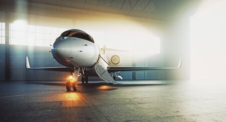 Business private jet airplane parked at maintenance hangar and ready for take off. Luxury tourism and business travel transportation concept. 3d rendering.の写真素材