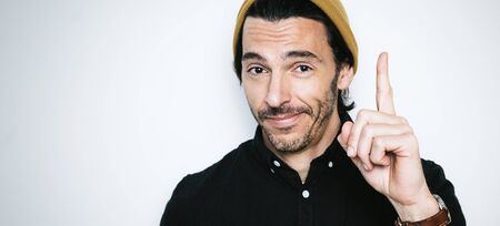 Portrait of a handsome man pointing finger upの写真素材