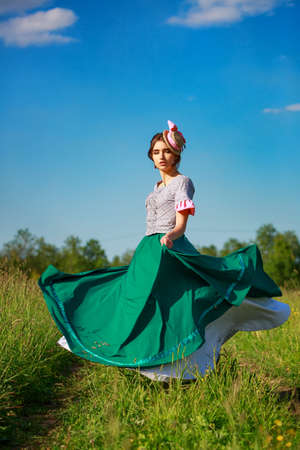 beautiful woman in dress in nature running on the road.の写真素材