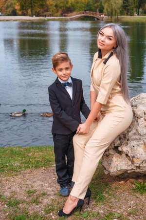mother and son walk in the Park by the lake.の写真素材