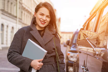 portrait of beautiful happy woman in coat outside smiling.