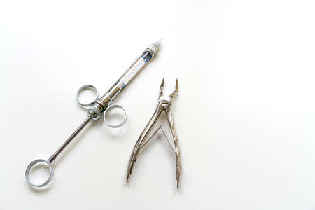 Dental instruments on a white background, syringe.