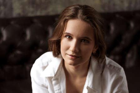 Portrait of a sexy young woman in a white shirt.