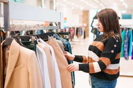 Woman chooses clothes in a store.の写真素材
