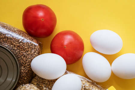 Food delivery on a yellow background, eggs and cere.の写真素材