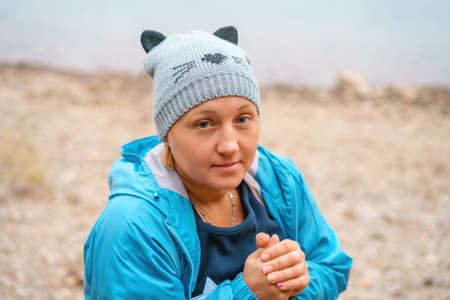 lovely woman in a knitted hat in a blue jacket.