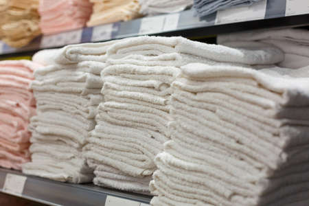 light towels in stacks on the shelf in the store, textile Section in the storeの写真素材