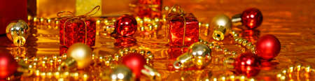 Christmas decor in gold and red color on a shiny backgroundの写真素材