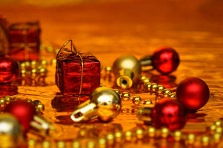 Christmas decor in gold and red color on a shiny backgroundの写真素材