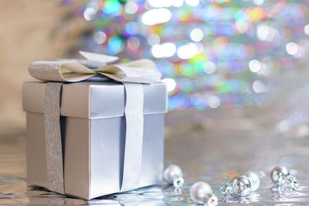 Silver gift box with christmas balls on silver backgroundの写真素材