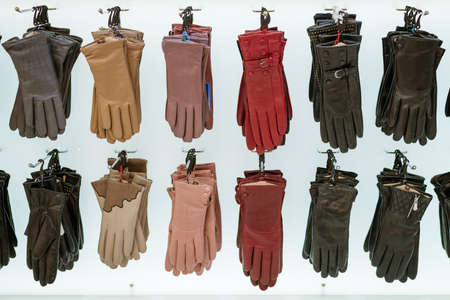 leather gloves of different colors and sizes on the shelf in the storeの写真素材