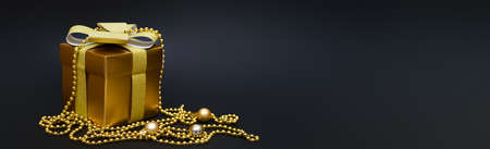 Golden gift box with christmas balls and golden beads on black background