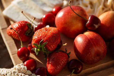 fresh fruits on a picnic in the summer close-up on the sun
