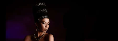 woman queen Cleopatra art photo, creative makeup Black hair braids and carnival ethnic costume on...