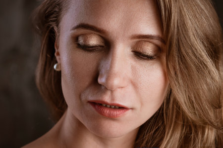 portrait of an adult woman close-up clean skin on a dark background beautiful eyesの写真素材