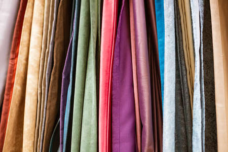 different types of curtains and fabrics hanging close-upの写真素材