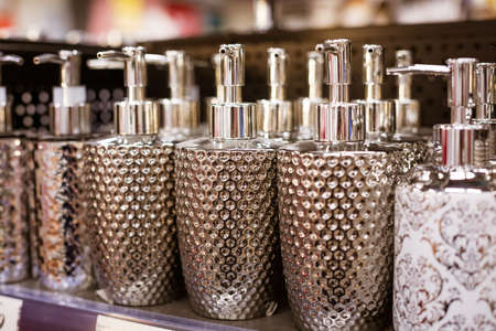 dispenser for liquid soap from glass on a shelf in a store, close-up soft focusの写真素材