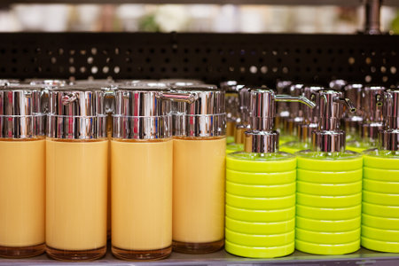 colorful plastic soap dispensers lined up on the store shelfの写真素材
