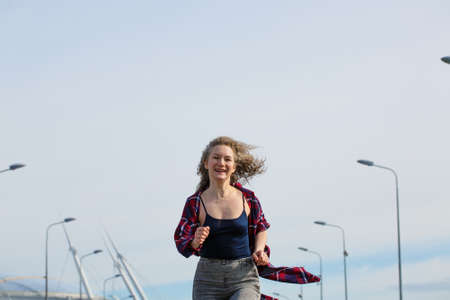 Happy caucasian woman running down the street with lanterns on the sky fne, healthy lifestyle...