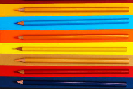 Colored pencils on a multi-colored background. Many pencils of different colors. Color pencil. The pencils are sharp. Close-up. Copy space. Background. Flat layの写真素材
