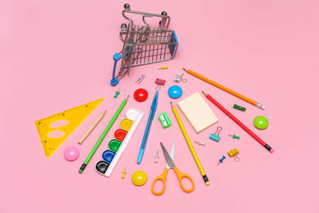 Trolley banner with school supplies on pink background. Back to school concept. Buying stationery...