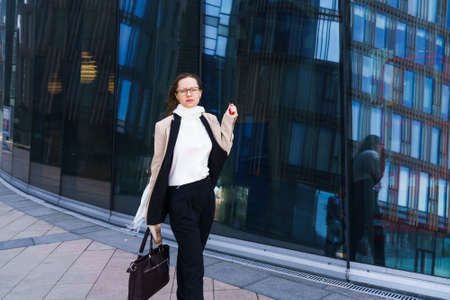 Successful happy business woman in glasses, Caucasian ethnicity in stylish business clothes with a...