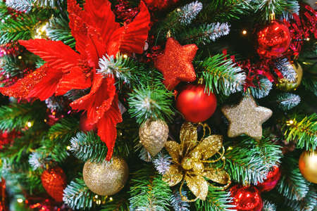 Beautiful christmas tree with decor as background. Christmas lights decorated with balls on tree in...