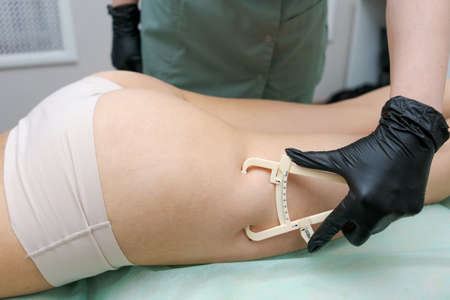 Woman was receiving treatment for cellulite. Slimming vacuum massage machine. Vacuum massage of the...