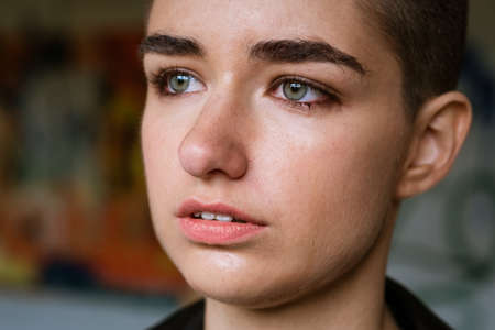 Close up sad young caucasian woman feeling unhappy depressed crying at home. Working millennial girl feels lonely and abandoned, suffering from a psychological problem. Miscarriage, singleton concept.の写真素材