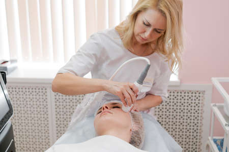 Lymphatic drainage massage apparatus massage process. Therapist cosmetologist makes a rejuvenating...