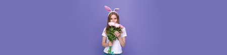 Easter holidays, spring concept - happy funny, crazy young girl in headband with rabbit ears holding...