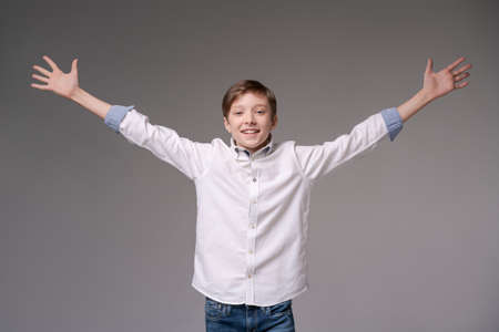 Young man screaming with happiness, celebrating triumph and victory, clenching fists, cant return to...