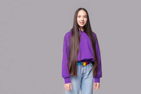 Portrait beautiful hipster girl wearing purple blank sweatshirt or sweatshirt with space for your   design on a gray background in the studio. Layout for printing. Techno styleの写真素材