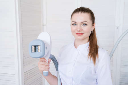 Woman doctor in medicine salon holds vacuum massage apparatus. Anti-cellulite body shaping procedure. Apparatus for weight loss. Woman and doctor in medicine salon.の写真素材