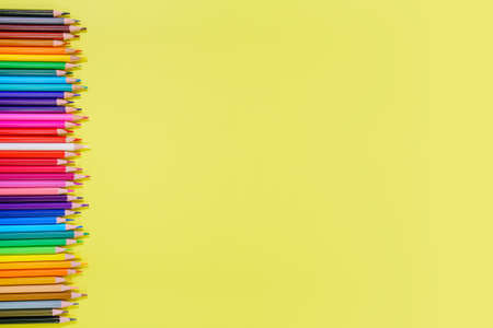 Many different colored pencils on a yellow background. Place your textの写真素材