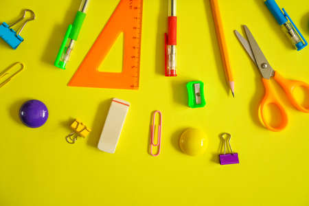 Tools for school creative work on a yellow background stationery, corondash pen scissors flat settingの写真素材