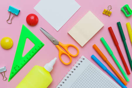 Stationery colorful writing supplies pens pencils blockton on spring, colored paper pink background. Back to school. Office suppliesの写真素材