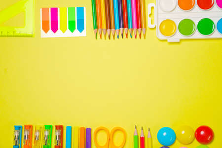 School supplies for drawing, paints colored pencils and pens paper stickers bright stationery on a...