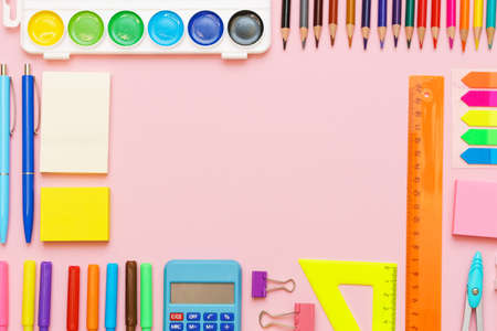 School supplies, colored pencils and watercolor paint pens, sticky notes on a blue background. Back to school creative, mockup concept.の写真素材