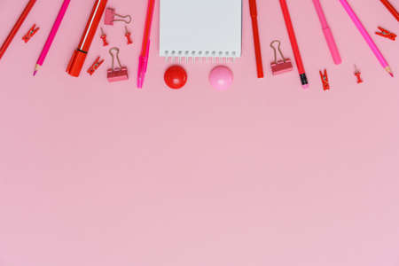 Stationery colorful writing supplies pens pencils blockton on spring, colored paper pink background. Back to school. Office suppliesの写真素材