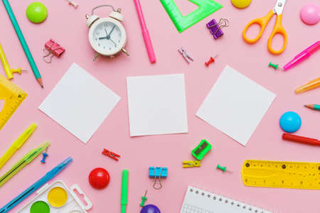 Stationery colorful writing supplies pens pencils blockton on spring, colored paper pink background....
